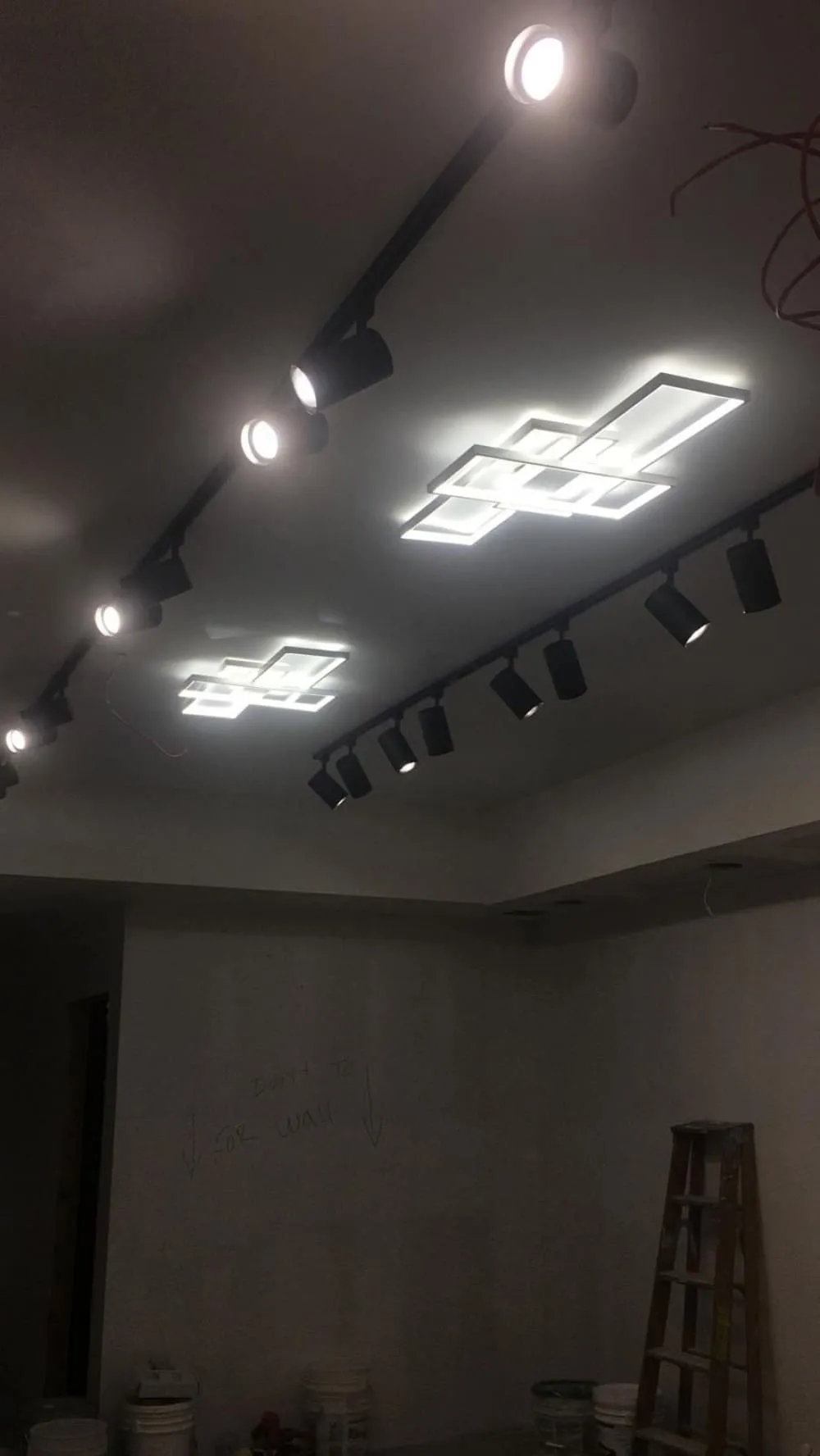 Commercial interior with modern track and panel lighting